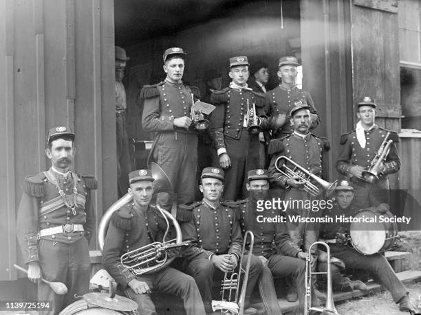 Brass band musicians in uniform pose with their instruments, Black River Falls, Wisconsin, 1895.
