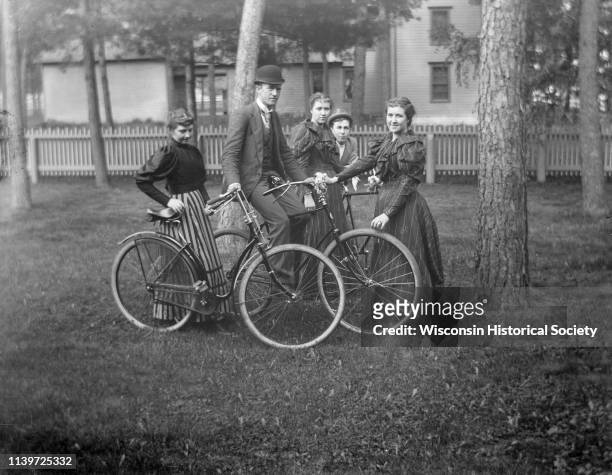 Sidney Catle, on bike, stands with his sister Sarah to his right, Harvey Richards, and twin sisters, Black River Falls, Wisconsin, 1900.
