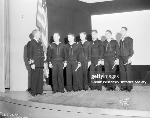 Commander Leslie K Pollard and six honor students from the US Naval Training School , Division, University of Wisconsin-Madison, pose for a group...