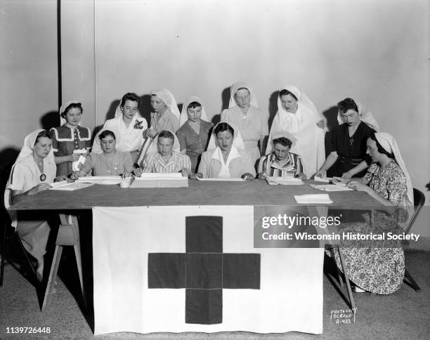 State female employees making surgical dressings / bandages for the American Red Cross in the Wisconsin State Employees Association building, 448 W...