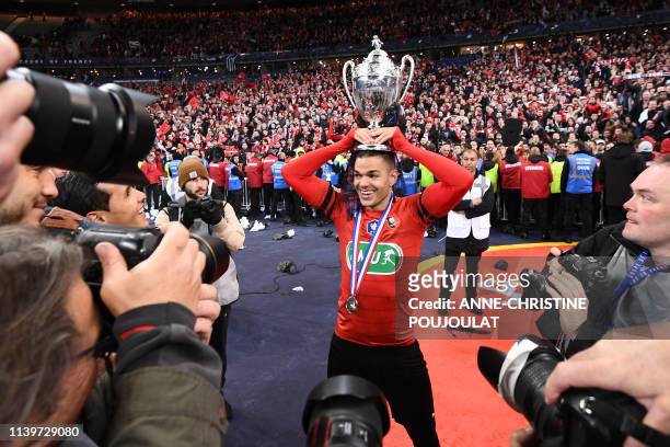 Rennes' French forward Hatem Ben Arfa celebrates with the trophy after winning the French Cup final football match between Rennes and Paris...