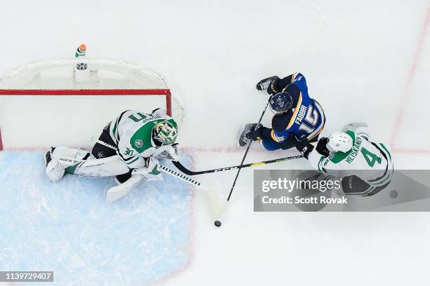 Ben Bishop of the Dallas Stars and Gavin Bayreuther of the Dallas Stars defend the net against Robby Fabbri of the St. Louis Blues in Game Two of the...