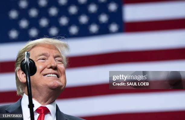 President Donald Trump smiles during a Make America Great Again rally in Green Bay, Wisconsin, April 27, 2019.