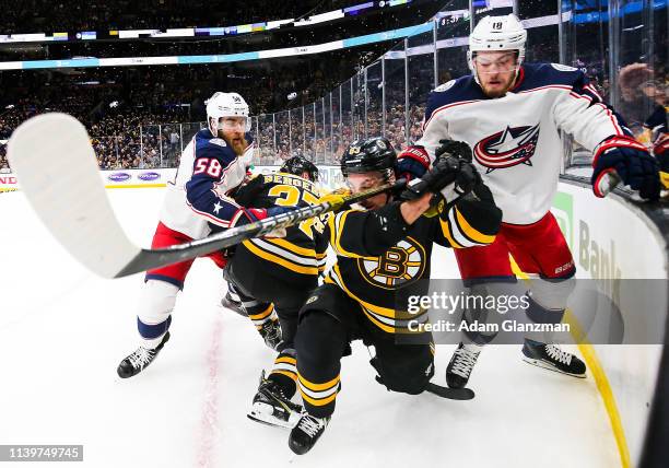 Brad Marchand of the Boston Bruins and Pierre-Luc Dubois of the Columbus Blue Jackets battle for the puck in Game Two of the Eastern Conference...