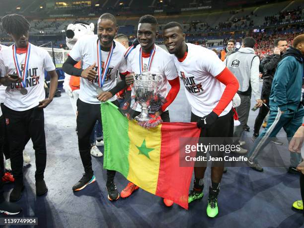 Senegalese players Abdoulaye Diallo, Ismaila Sarr, MBaye Niang of Stade Rennais celebrate the victory following the French Cup Final between Stade...