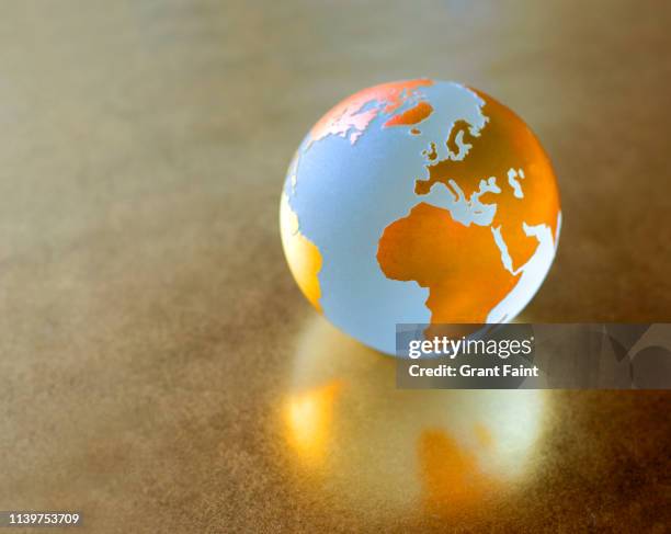 view of globe on gold background. - globalizacion fotografías e imágenes de stock