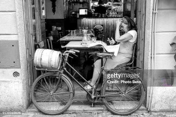an adult woman enjoys italian cuisine in a typical trastevere restaurant in the historic heart of rome - vintage italy stock pictures, royalty-free photos & images