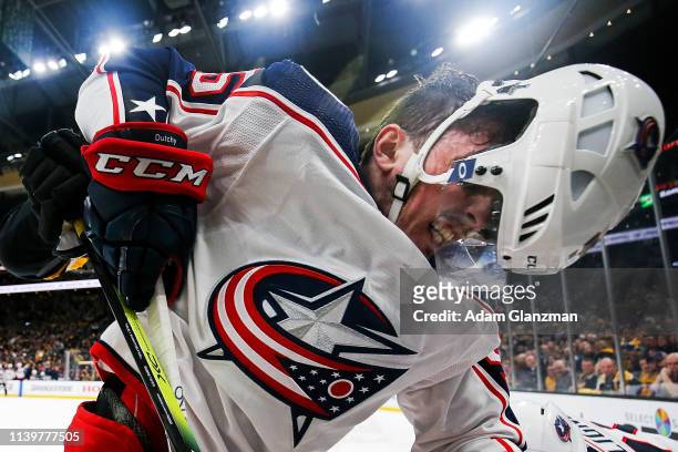 Matt Duchene of the Columbus Blue Jackets loses his helmet as he battles for the puck with Zdeno Chara of the Boston Bruins in Game Two of the...