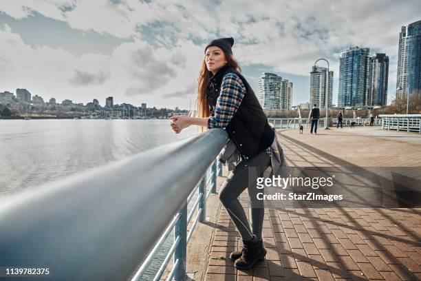 young woman enjoying vancouver during the autumn - vancouver stock pictures, royalty-free photos & images