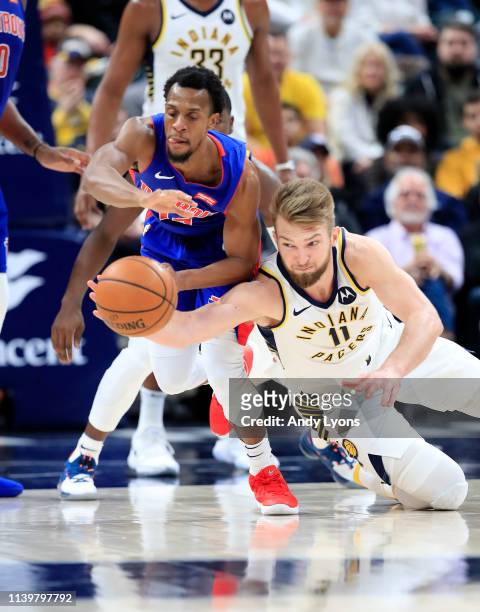 Domantas Sabonis of the Indiana Pacers and Ish Smith of the Detroit Pistons battle for a loose ball during the game at Bankers Life Fieldhouse on...