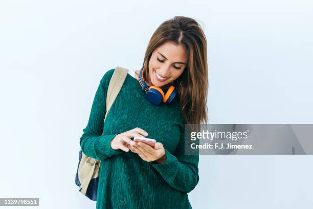 woman using mobile phone on white background - cellphone white background stock-fotos und bilder