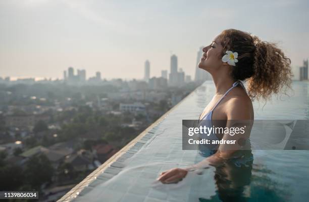 happy woman in the infinity pool at a hotel in sri lanka - colombo stock pictures, royalty-free photos & images