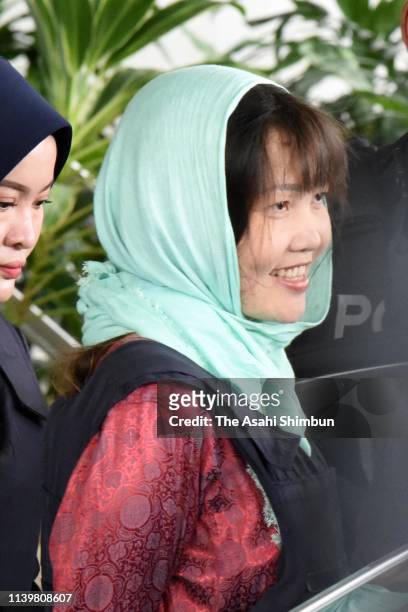 Vietnamese Doan Thi Huong, as she smiles escorted by police after a court session for her trial at the Shah Alam High Court for murder case of Kim...