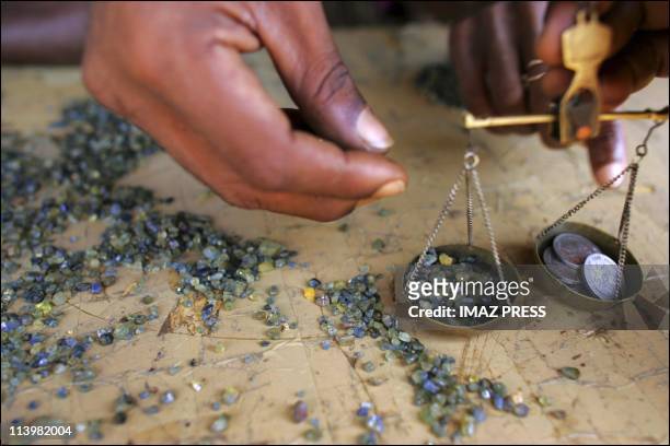 Sapphire mine in Madagascar In August, 2005-Weighing a set of stones in Ambondromifehy.