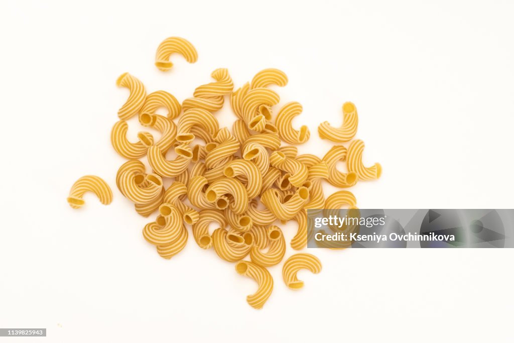 Food and drink concept - various uncooked pasta on white background. Top view.