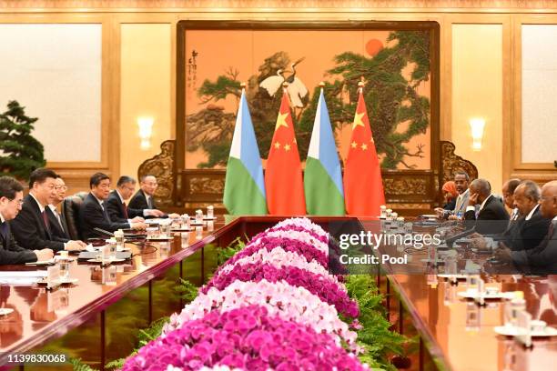 China's President Xi Jinping, second left, attends a meeting with Djibouti's President Ismail Omar Guelleh, second right, at the Great Hall of the...