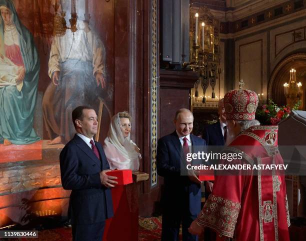 Russian President Vladimir Putin , Prime Minister Dmitry Medvedev , his wife Svetlana and Moscow Mayor Sergei Sobyanin present gifts to Russia's...