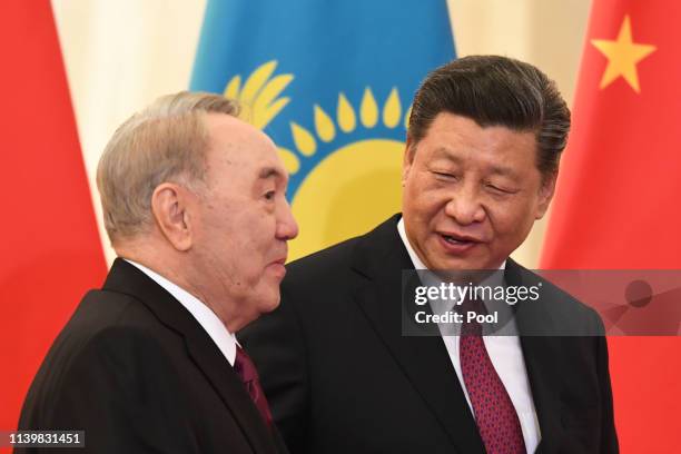 China's President Xi Jinping, right, speaks to Kazakhstan's Former President Nursultan Nazarbayev piror to their meeting at the Great Hall of the...