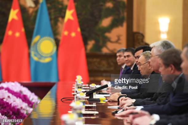 Kazakhstan's Former President Nursultan Nazarbayev, fourth right, attends a meeting with China's President Xi Jinping at the Great Hall of the People...