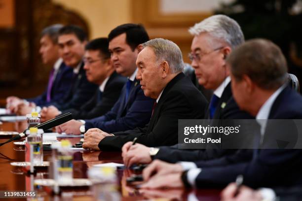 Kazakhstan's Former President Nursultan Nazarbayev, third right, speaks during a meeting with China's President Xi Jinping at the Great Hall of the...