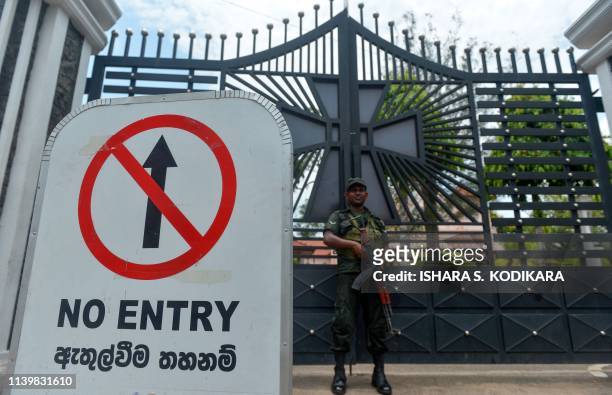 Sri Lankan soldier stands guard near St. Sebastian's Church in Negombo on April 28 a week after a series of bomb blasts targeting churches and luxury...