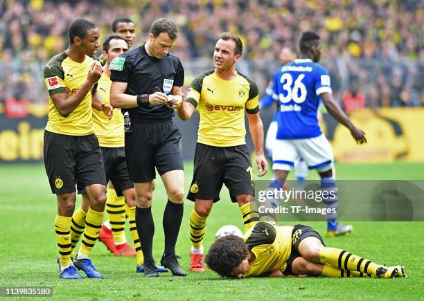 Abdou Diallo of Borussia Dortmund and Mario Goetze of Borussia Dortmund speak with referee Felix Zwayer during the Bundesliga match between Borussia...