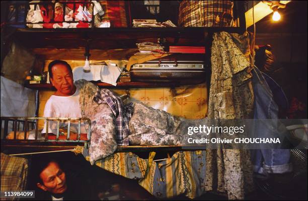 Cage people, or the issue of precariousness in Hong Kong city, Hong Kong in March, 2006-Mister Wong Tung and Cheuk Yau in their cage home in the area...