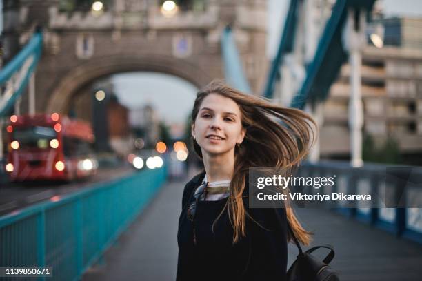 a young woman at tower bridge, london, uk - london bridge stock pictures, royalty-free photos & images