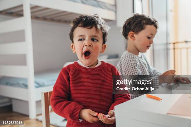 boys drawing at home - yawning stock pictures, royalty-free photos & images
