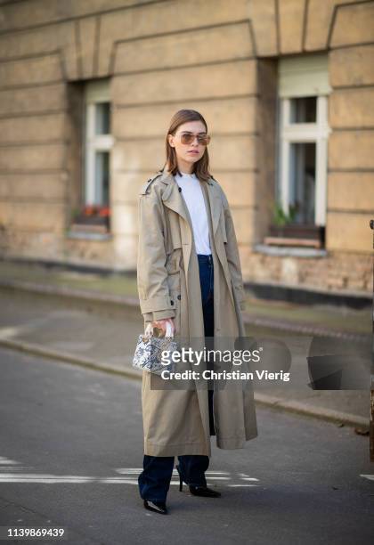 Swantje Sömmer is seen wearing trench coat DAY, Calvin Klein jeans, Dior bag, black mules Dorateymur, Miu Miu sunglasses on April 01, 2019 in Berlin,...