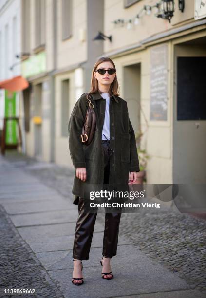 Swantje Sömmer is seen wearing corduroy button shirt Zara, leather pants Mango, Dior saddle bag, Zara heels, Rayban sunglasses on April 01, 2019 in...