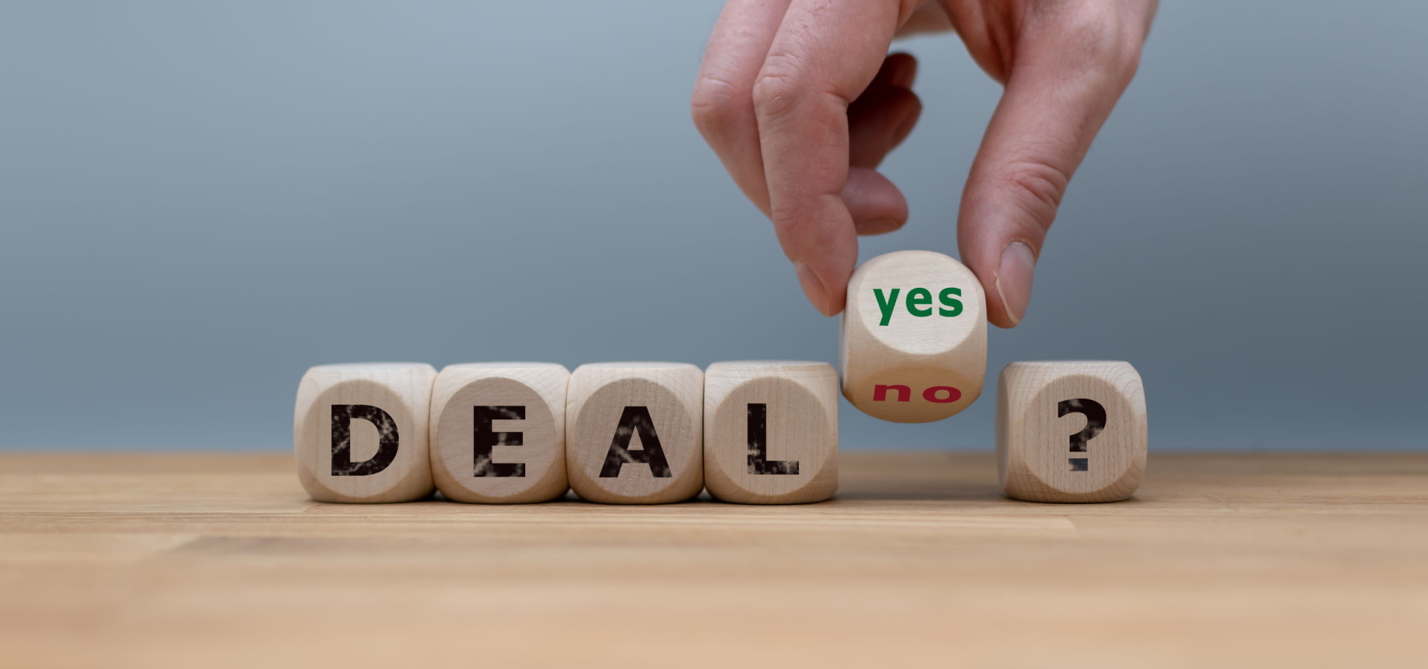 Deal or no deal? Hand turns a cube and changes the word Deal or no deal? Hand turns a cube and changes the word