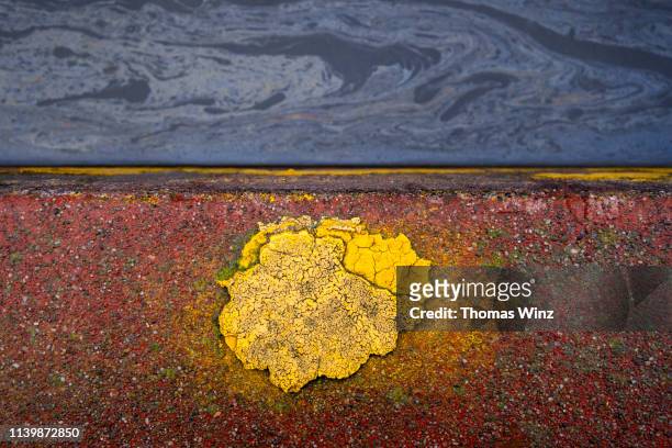 chipped yellow paint on a curb - kerb stock pictures, royalty-free photos & images