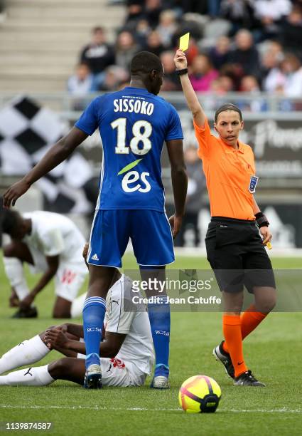 First woman ro referee a Ligue 1 match, Stephanie Frappart gives a yellow card to Ibrahima Sissoko of Strasbourg during the French Ligue 1 match...