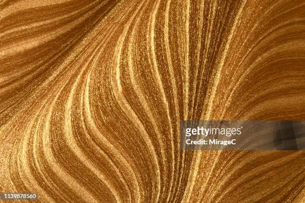 mixing of gold colored paint - bronskleurig stockfoto's en -beelden