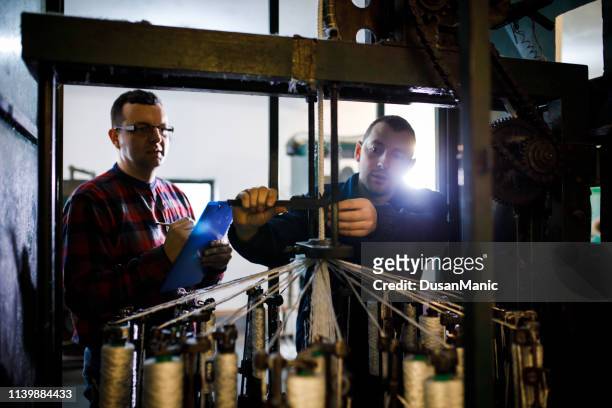 two businessman working in factory. - spinning coin stock pictures, royalty-free photos & images
