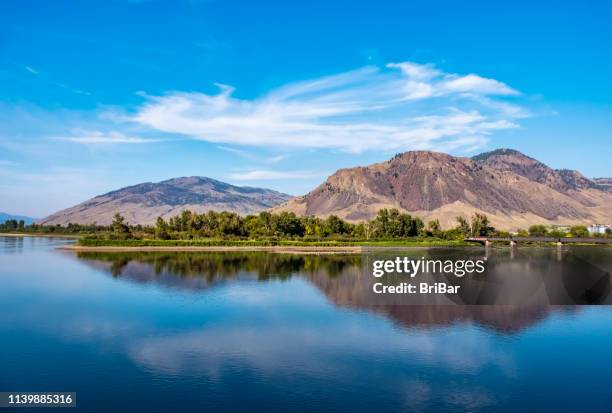 kamloops, bc - thomson river, mountain range and railway bridge - british colombia stock pictures, royalty-free photos & images