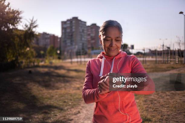 athlete woman check smartwatch - taking pulse stock pictures, royalty-free photos & images