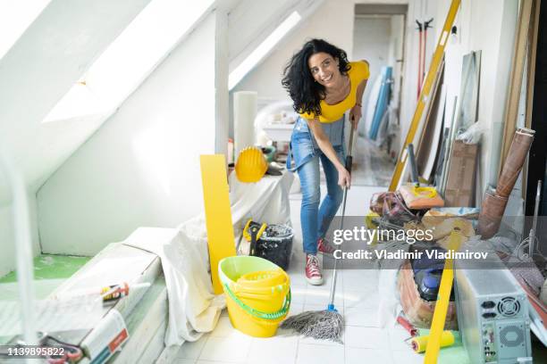 woman cleaning up apartment after home repair - attic conversion stock pictures, royalty-free photos & images