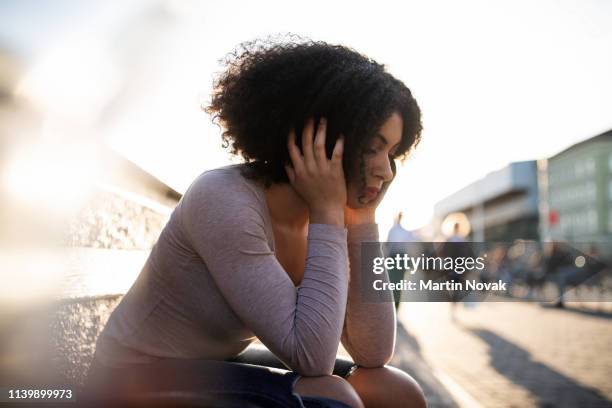 unhappy young woman feeling low - verlegen stockfoto's en -beelden