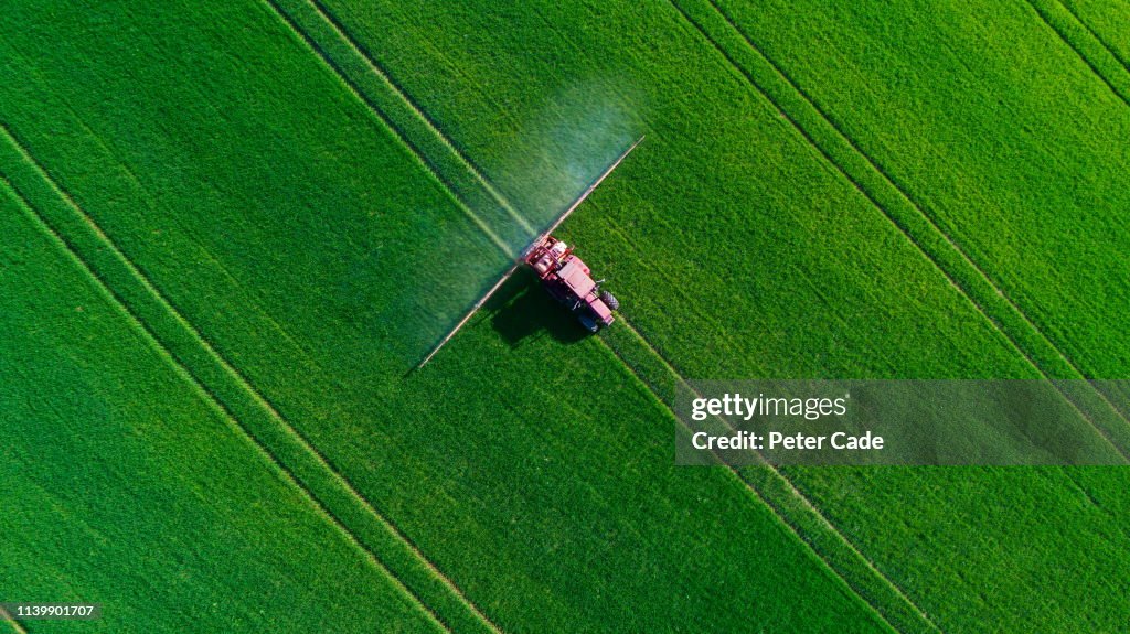 Tractor spraying field