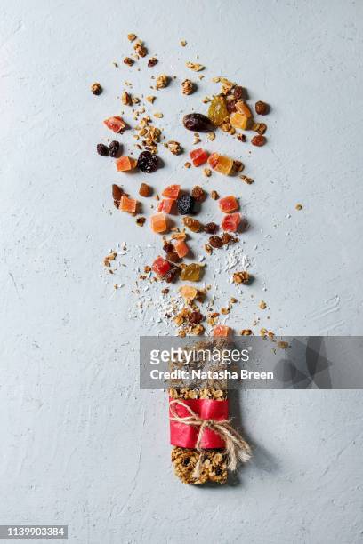energy granola bar - berries white background stock-fotos und bilder