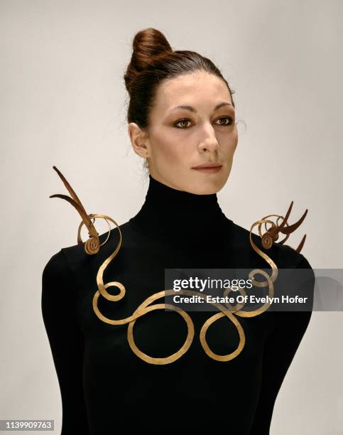 Portrait of American fashion model Anjelica Houston as she poses in a necklace , New York, 1976.