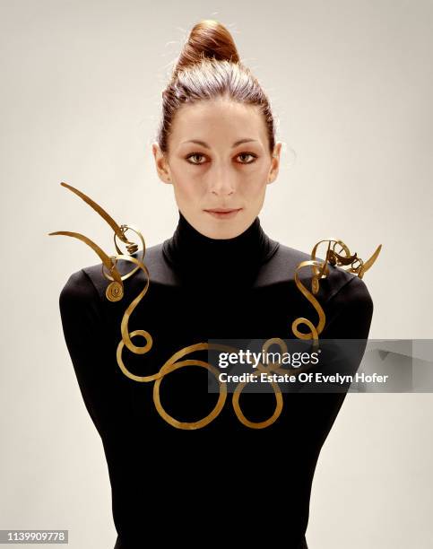 Portrait of American fashion model Anjelica Houston as she poses in a necklace , New York, 1976.