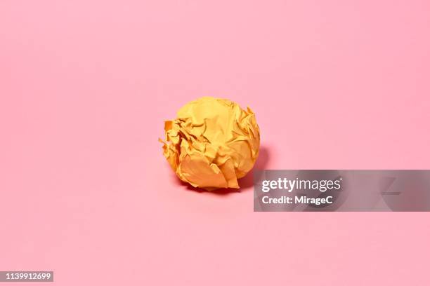 crumpled paper ball on pink background - crumpled paper ball stock-fotos und bilder