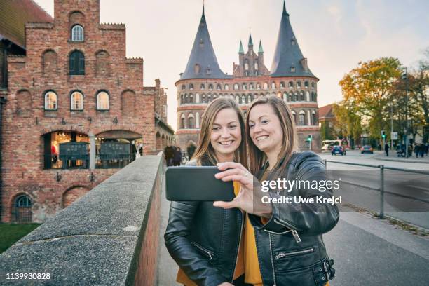 two young women taking self portrait - identical twin stock pictures, royalty-free photos & images