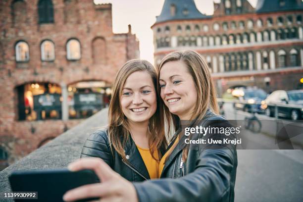 two young women taking self portrait - identical twin stock pictures, royalty-free photos & images