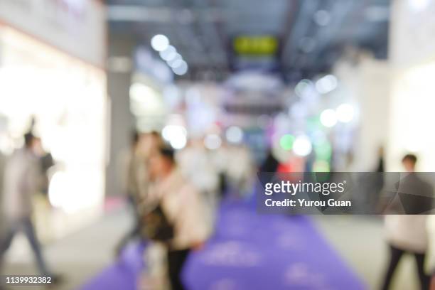 defocus background of public exhibition in trade show . abstract background used for business. - tradeshow stock pictures, royalty-free photos & images