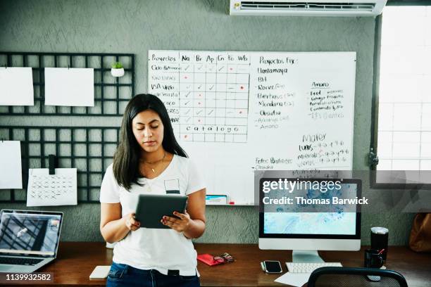 female graphic designer working on digital tablet in design studio - latin america technology stock pictures, royalty-free photos & images