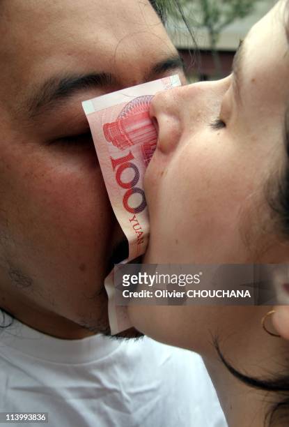 Performance Art in Beijing, China in 2007-Chinese performance artist Zhou Bing during his performance called '100 Yuan' where him and a western...